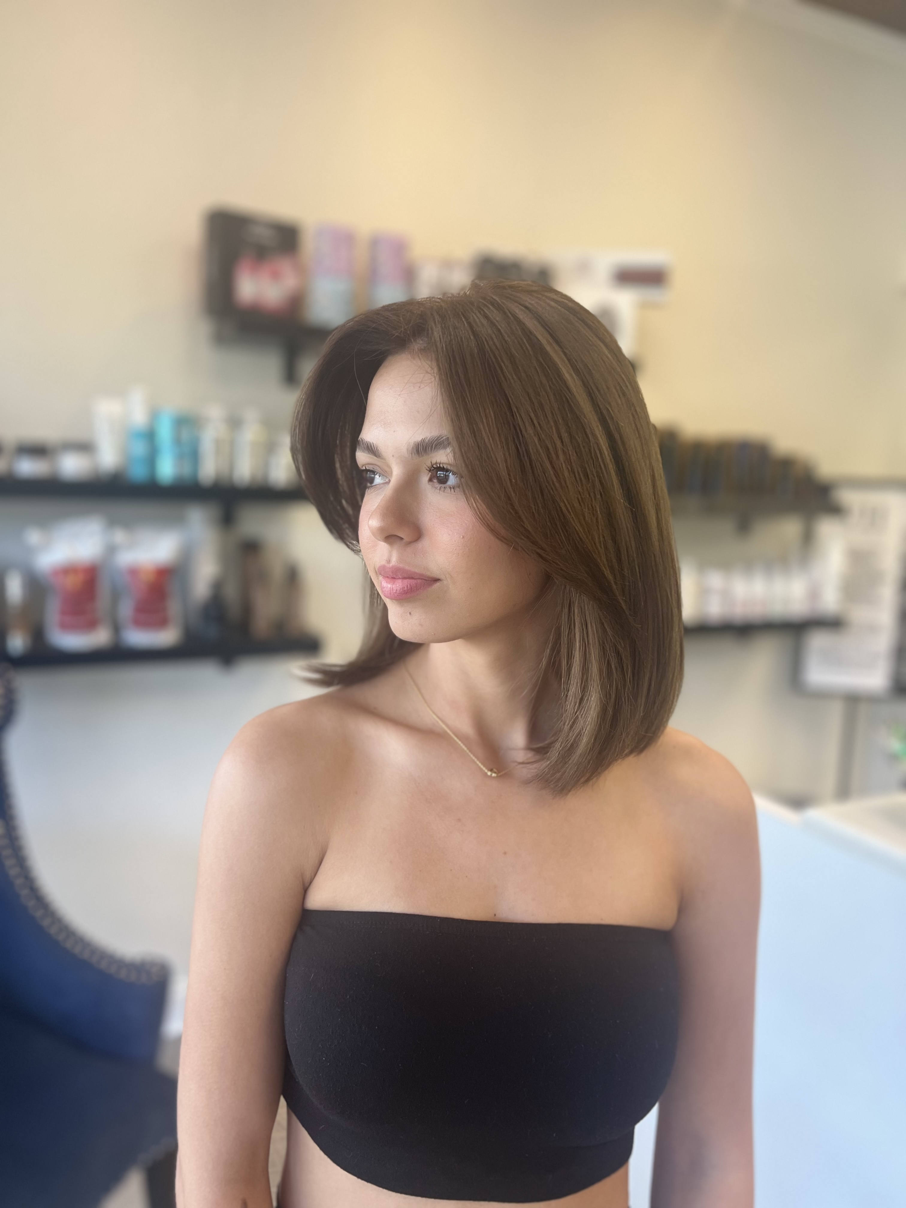 Brunette bob haircut, side profile inside the salon